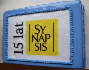 Biało-niebieski tort z czarnym napisem 15 lat | SYNAPSIS |.