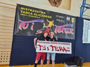 Dwóch mężczyzn stoi i trzyma baner zawodów.