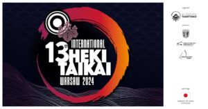 Czarne tło. Pomarańczowy okrąg. Napis International 13th HEKI TAIKAI WARSAW 2024