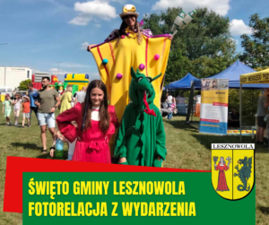 Na zdjęciu chłopiec i dziewczyna przebrani za postacie z herbu Gminy Lesznowola - pannę i smoka, pozują do zdjęcia razem z klaunem na szczudłach.